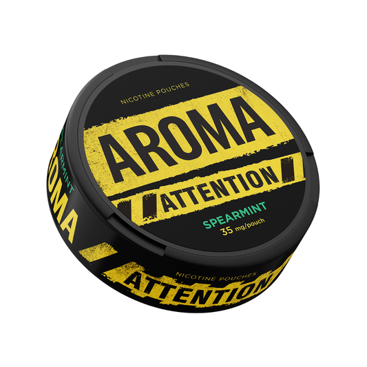 Detail close-up of a black canister with yellow label text and screw top, showcasing Aroma Attention Spearmint.