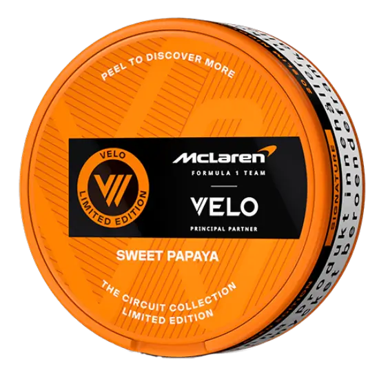 Detail close-up of the orange circular can featuring branding logo and flavor description on a transparent background