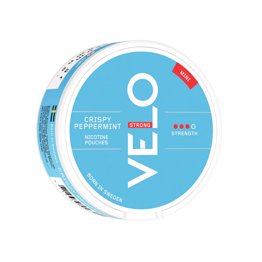 Detail close-up of Velo Crispy Peppermint Mini snus can in blue and white, showcasing the logo and flavor on a white backg…