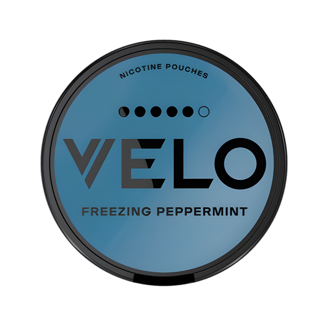 Detail close-up of a blue and black snus can featuring the Velo logo and flavor name on a transparent background